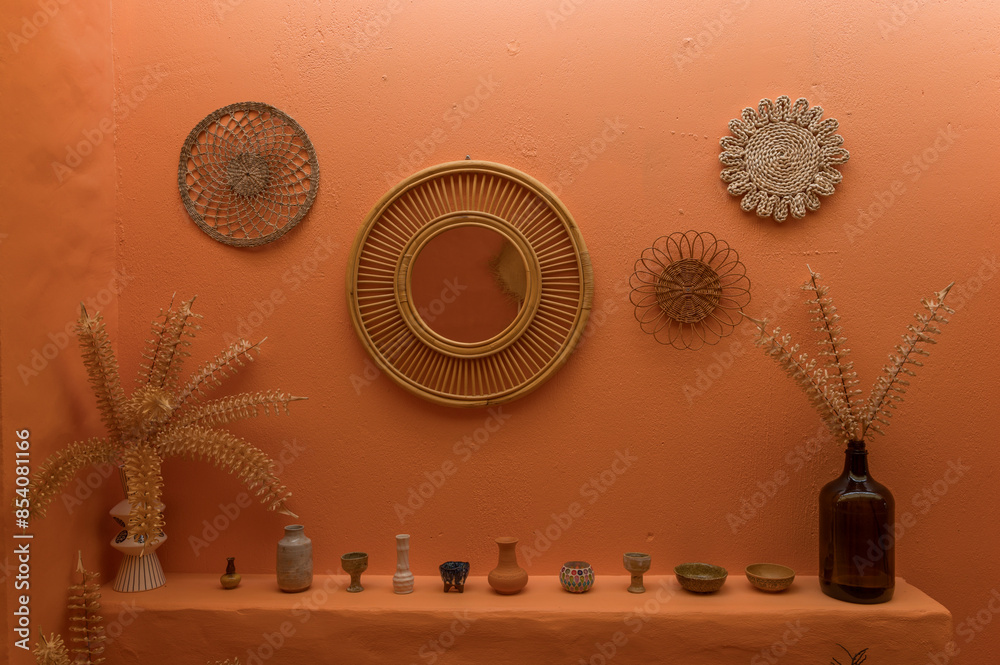Poster an interior wall decorated with woven baskets and various ornaments, creating a warm and artistic di