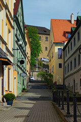 Scenic view of the historical street of medieval Loket with colorful buildings and cobblestone road by summer day. Bohemia, Sokolov, Karlovarsky Region, Czech Republic. UNESCO World Heritage Site