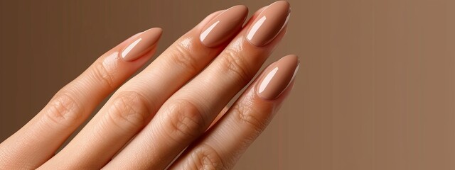 Fototapeta premium A women's hand with manicured nails against a brown backdrop ..Or, for a more descriptive version:..Close-