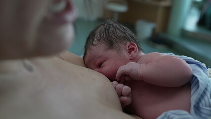 Intimate First Moments/ Newborn Infant Breastfeeding Right After Birth, Focused on Mother-Child...