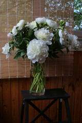 Blurred floral background. A bouquet of white peonies