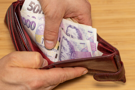 Hand takes out money from the wallet, Czech koruna banknotes, concept, rising prices, value of Czech currency