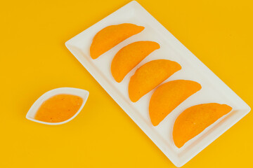 Delicious traditional Colombian empanadas with spicy sauce