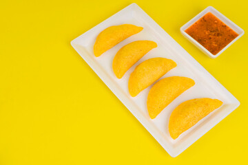 Delicious traditional Colombian empanadas with spicy sauce