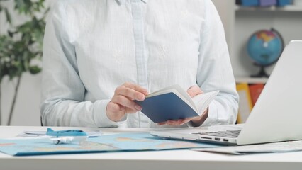 Travel agent working at a laptop