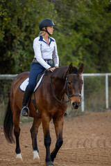 Women equestrian riding english bay horse