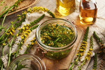 Preparation of herbal tincture with blooming agrimony - macerating the plant in alcohol