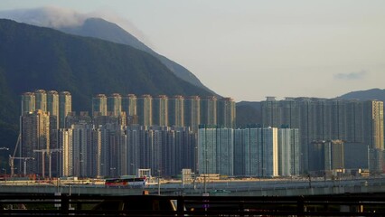 Hong Kong - March 28, 2024: View of tall residential buildings with mountains in the background