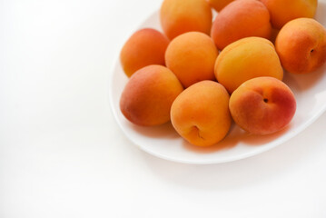 Yellow plums on a white plate. Fresh fruits.