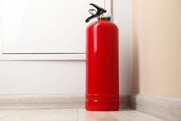 Fire extinguisher on floor indoors. Safety equipment