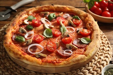 Delicious pizza with salami, vegetables, mushrooms and basil on table, closeup