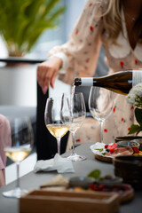 Wine tasting. Sommelier pours wine into a glass