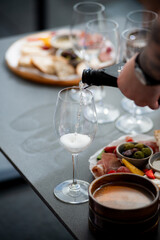 Wine tasting. Sommelier pours wine into a glass
