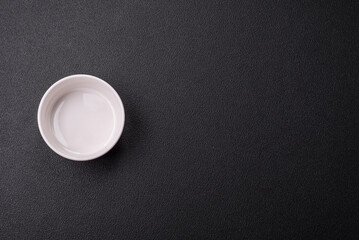 Beautiful empty white ceramic gravy boat on a concrete background