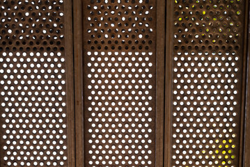 Decorative holey element suitable as a background