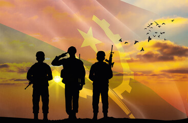 Silhouettes of soldiers with a background of the Angola flag and a sunset or sunrise. Concept of national holidays. Commemoration Day.