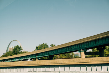 A Car Driving on a Highway Overpass With the Gateway Arch in the Background in St. Louis