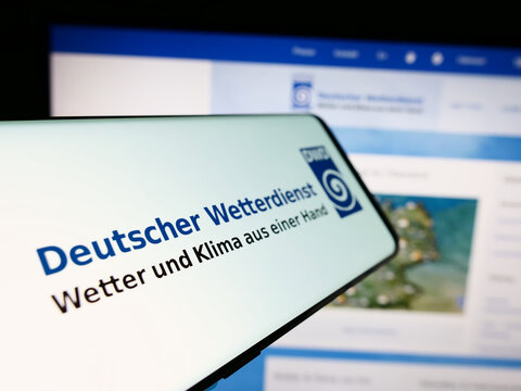 Stuttgart, Germany - 06-06-2024: Smartphone with logo of German meteorological service Deutscher Wetterdienst (DWD) in front of website. Focus on center-left of phone display.