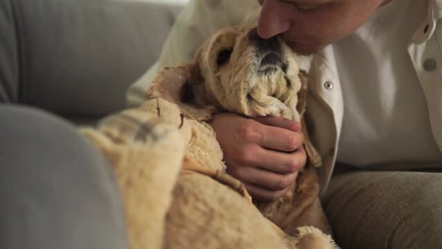 A man strokes his dog, and a dog licks his owner.
Love in animals.
A man pets his pet.