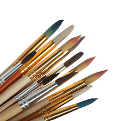 Many different paint brushes on white background