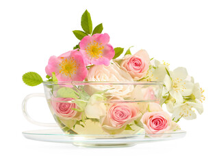 Aromatic herbal tea in glass cup with different flowers isolated on white