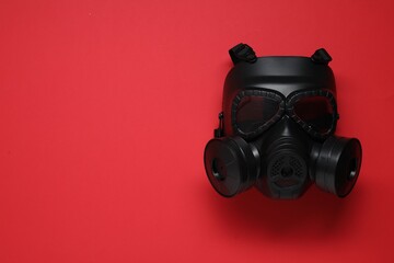 One gas mask on red background, top view. Space for text