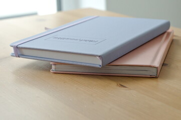 notebooks with text 'think positive' on wooden table