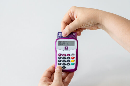 Hands using AIB (Allied Irish Banks) card reader for internet banking access