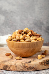 Mixed nuts on wooden background. Nuts in a bowl
