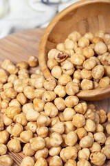 Hazelnuts on wood background. Roasted hazelnuts in a bowl. Close up