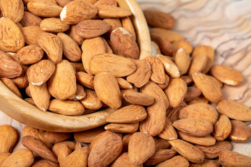Almonds on wood background. Roasted almonds in a bowl. Close up