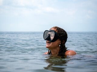 Woman Laughing While Snorkeling in Clear Ocean © DayfaPhoto