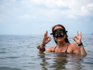 Woman Giving OK Sign While Snorkeling in Ocean