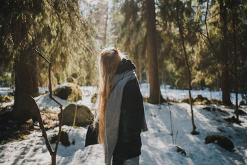person walking in winter forest