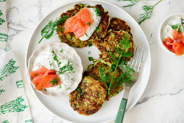 Zucchini pancakes with sour cream, smoked salmon and dill sauce.top veiw