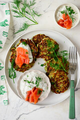 Zucchini pancakes with sour cream, smoked salmon and dill sauce.top veiw