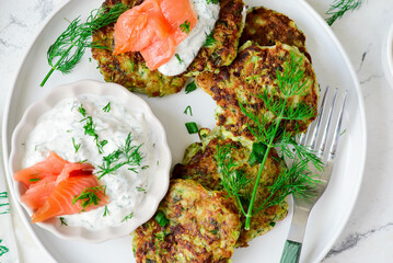 Zucchini pancakes with sour cream, smoked salmon and dill sauce.top veiw