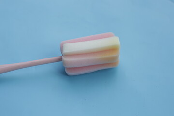 Sponge cleaning brush on blue background.