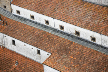 Naklejka premium Roofing, tiles on the roof of a building, traditional architecture, texture photo. Portugal