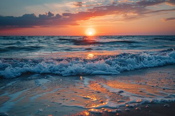 Naklejka premium Beautiful sunset over sea with foreground waves and colorful sky