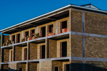 Construction of three-storey building in summer