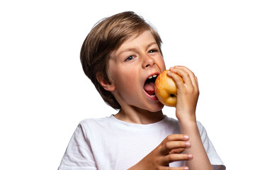 Portrait of handsome boy eating apple, isolated on white background