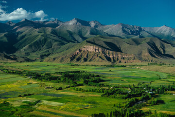 Obraz premium Picturesque mountain valley with meadows in springtime, aerial view