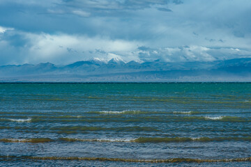 Issyk-Kul lake with mountains and clouds, Kyrgyzstan