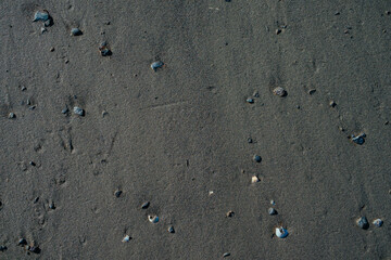 Black sand on beach texture or background