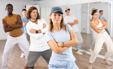 Fototapeta premium Group of active women and men practicing energetic dance in a modern dance studio
