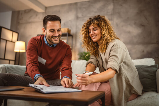 Woman sign insurance policy, contract to man financial adviser at home