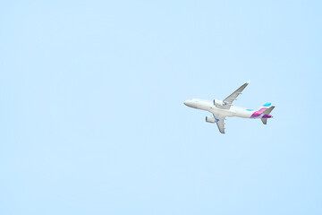 High flying airplane in blue sky. View from below