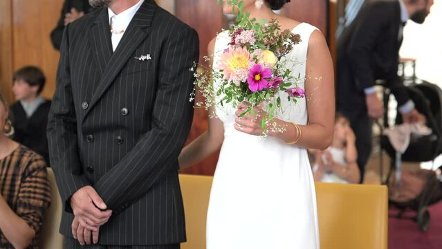 Illustration of a heterosexual marriage in a town hall. unrecognizable bride with beautiful flowers and groom. French wedding with two happy lovers.