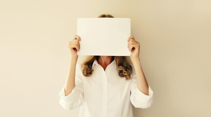 Woman showing and holding white blank sheet of paper document for advertising text blank copy space